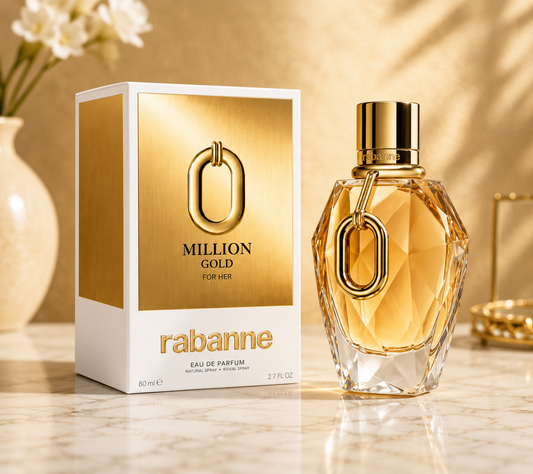 Rabanne Million Gold For Her Eau de Parfum bottle and its packaging box, displayed on a marble surface with a warm, sunlit background.
