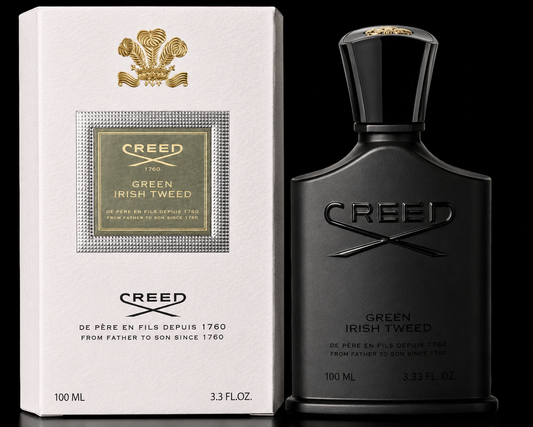 Creed Green Irish Tweed perfume bottle in matte black next to its white and gold packaging box, set against a solid black background.